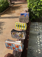 The Funky Fix bag held by its short handle, demonstrating its handheld carrying style.