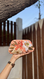 Angle view of the Garden Muse clutch showing the natural gathers due to the heavy rexine thickness.