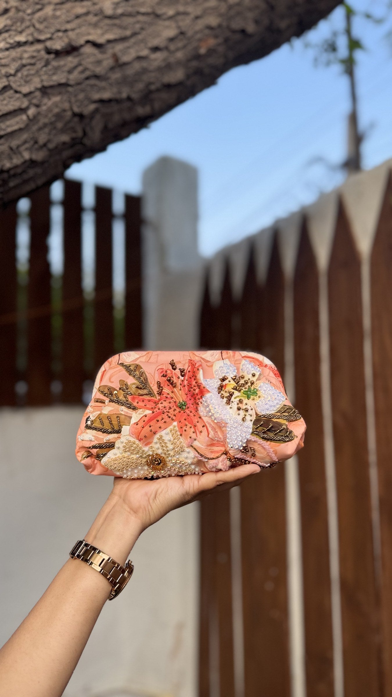 Angle view of the Garden Muse clutch showing the natural gathers due to the heavy rexine thickness.