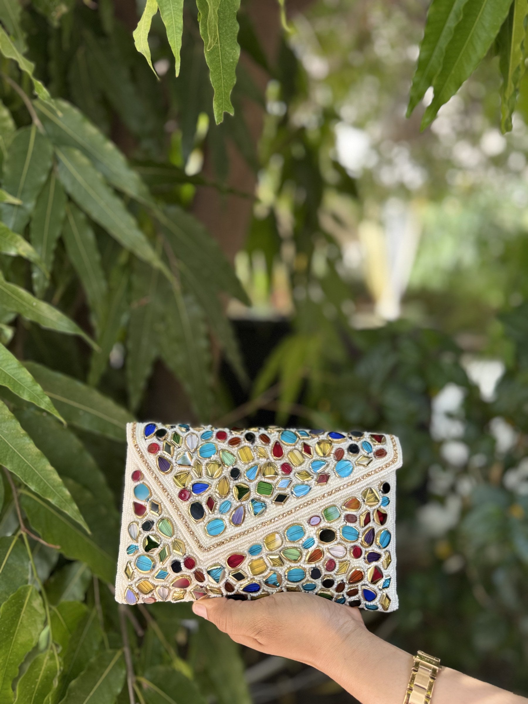 Detailed view of the handcrafted gemstone and glass bead embroidery on the flap of the Gemzy bag.