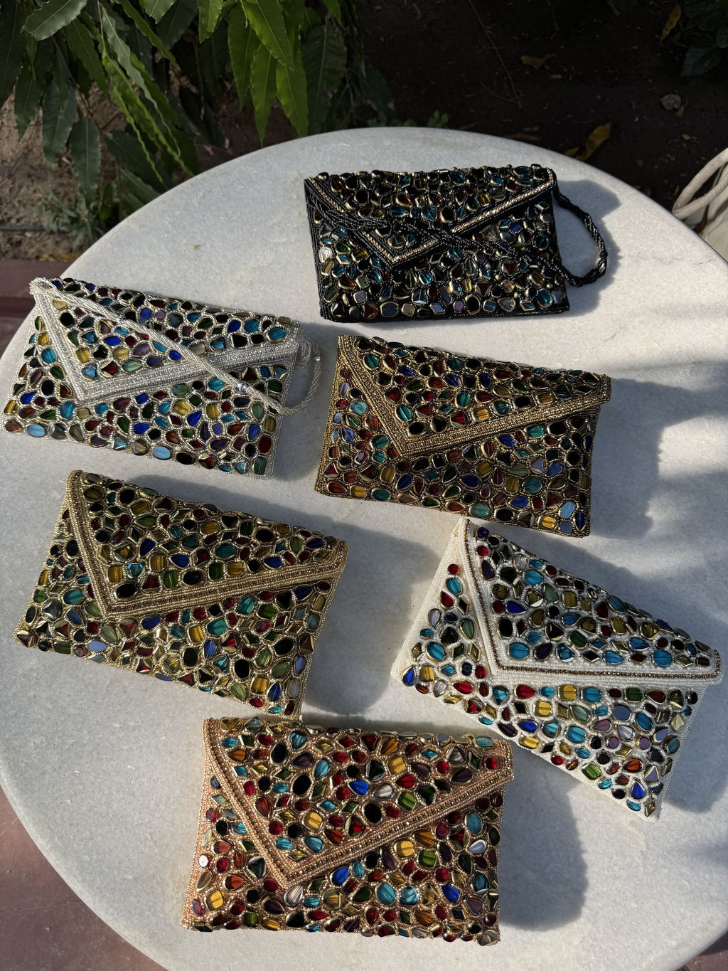 Back view of the Gemzy flap bag, illustrating the consistency of the artisan embroidery and fabric finish.