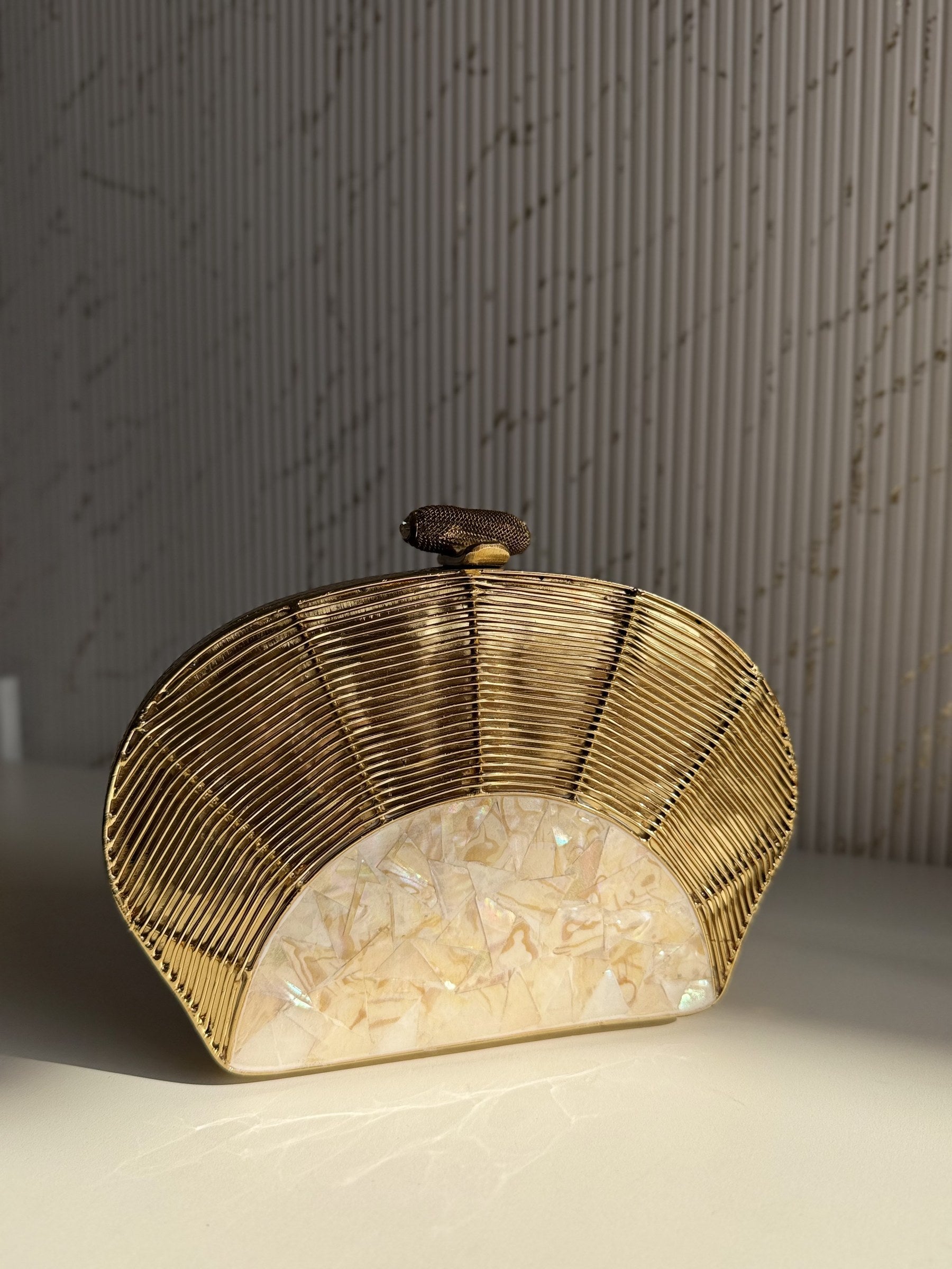 Detailed close-up of the sculpted floral and abstract patterns on the gold brass frame.