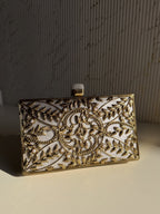 Gilded Muse rectangular clutch styled handheld against a traditional festive outfit.
