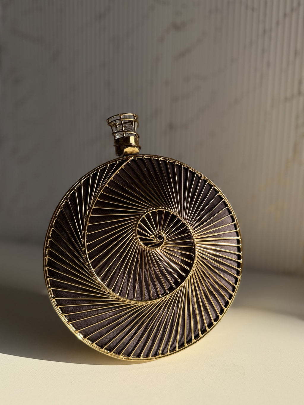 Open view of the rectangular brass clutch, illustrating its smooth interior and capacity for cardholders.