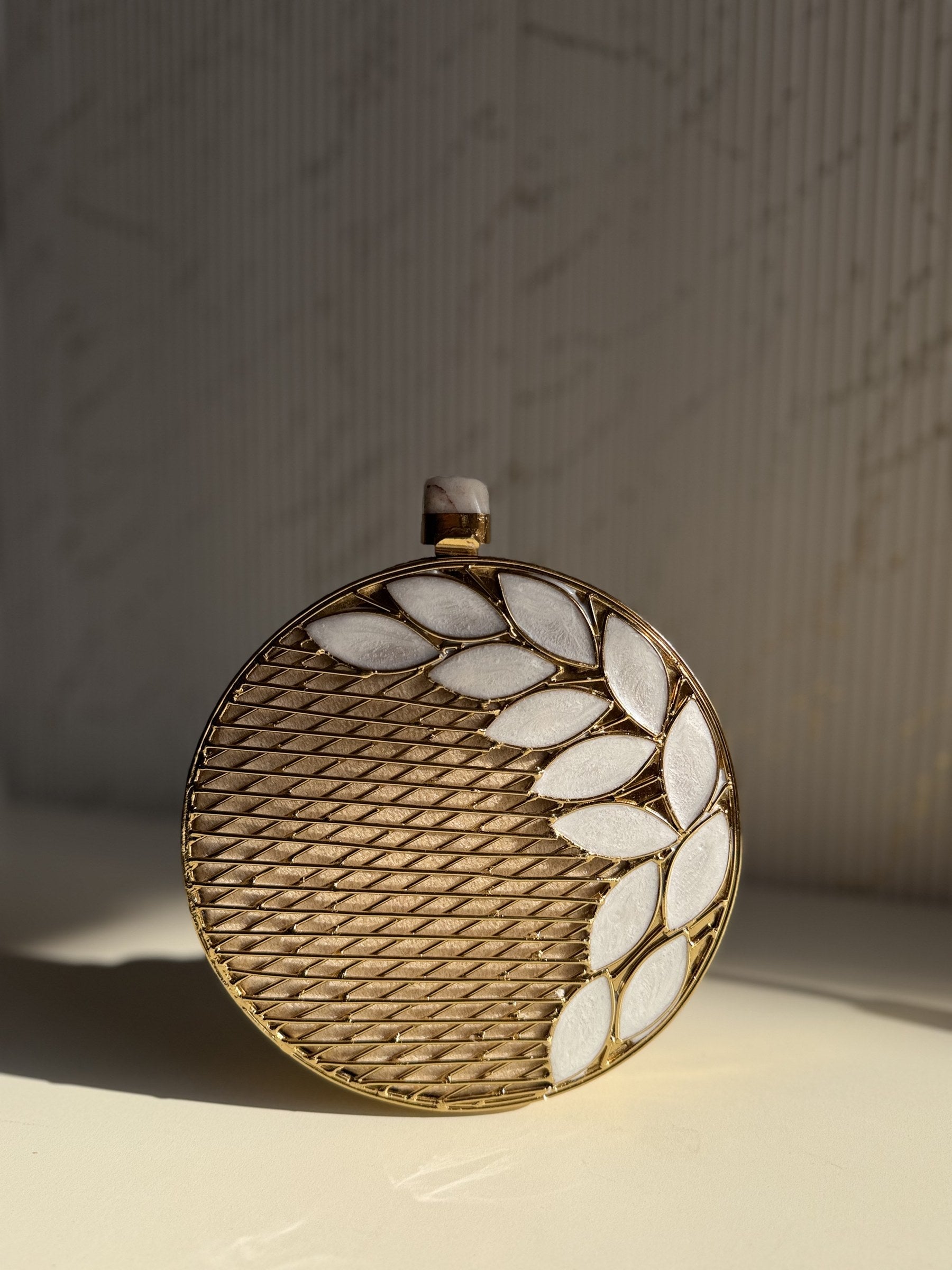 Side-by-side comparison of the rectangular and oval Gilded Muse clutches.