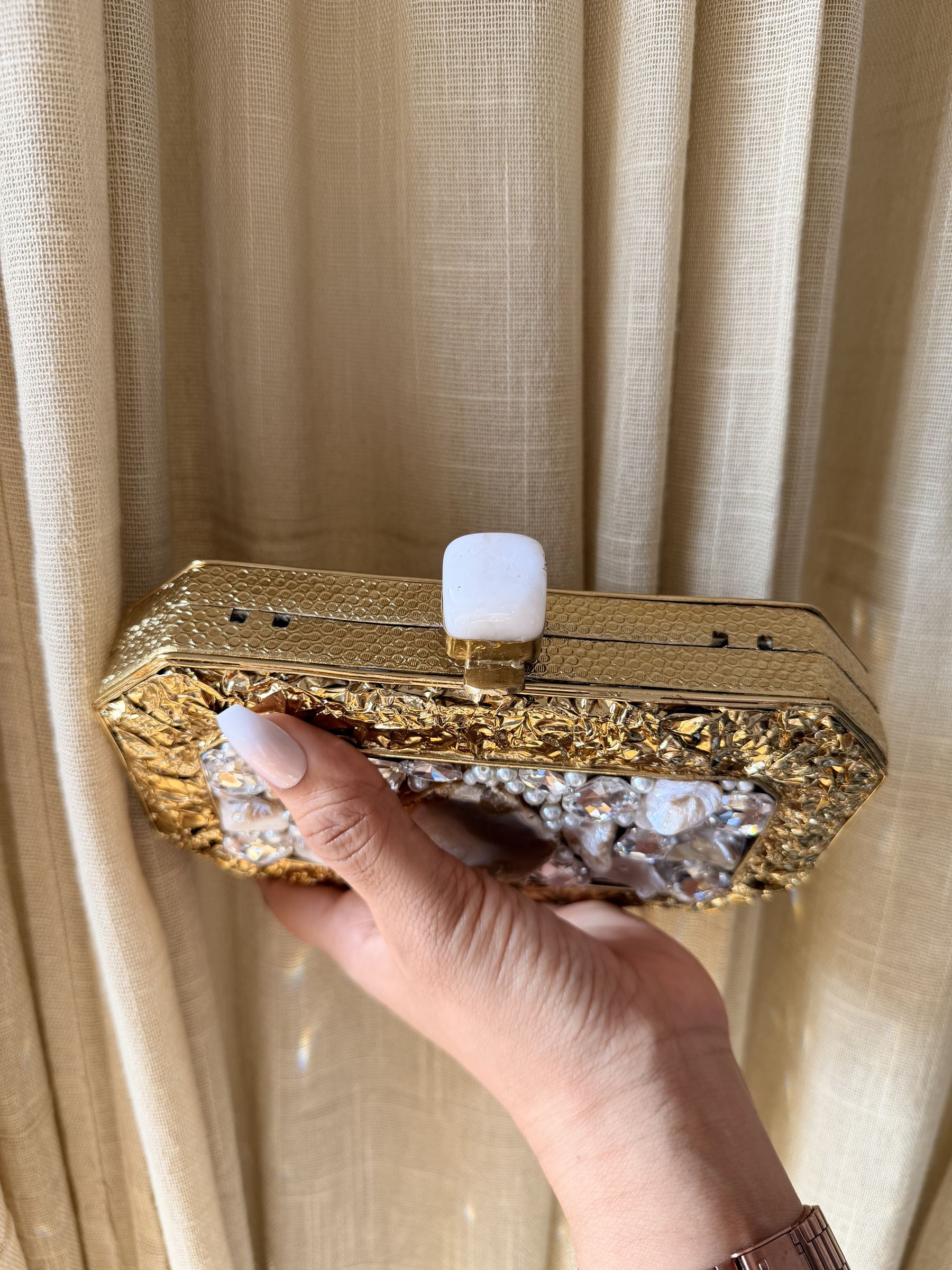 The Gilded Muse collection featuring rectangular, oval, and round silhouettes in gold.