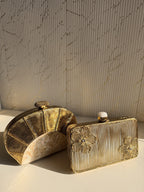 Gilded Muse rectangular clutch held in hand, highlighting its fit for modern smartphones.