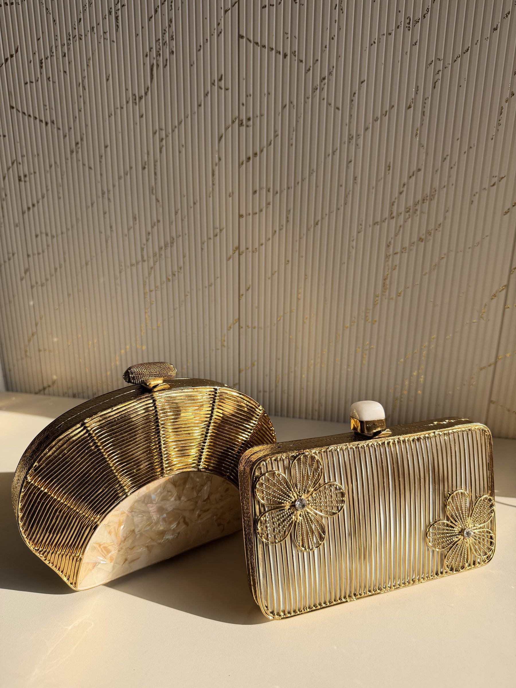 Gilded Muse rectangular clutch held in hand, highlighting its fit for modern smartphones.