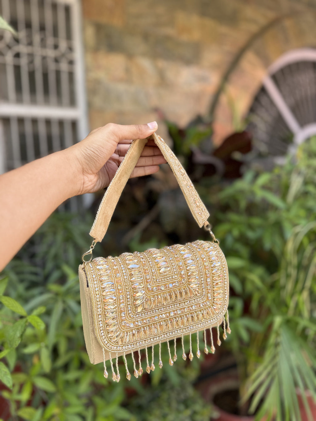 Glimmer Grip evening clutch displaying its sparkling sequin surface and gold-tone sling chain.