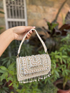 Side profile of the Glimmer Grip clutch showing the gold border frame and hinges.