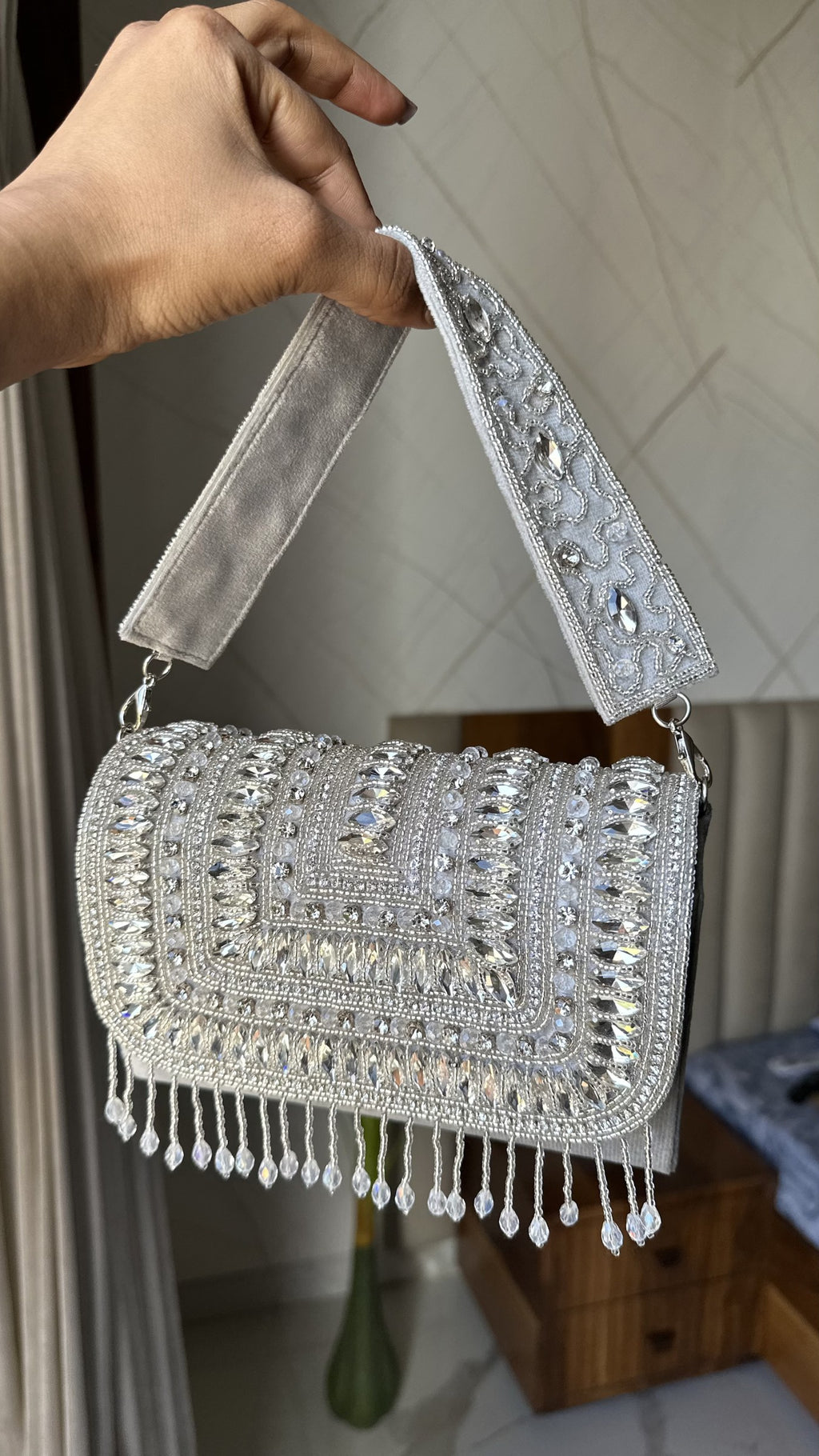 Angled shot of the Glimmer Grip bag, illustrating the gold frame details.
