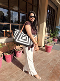 Front view of the Gridlock Tote in classic onyx black, showing its clean rectangular structure and shoulder straps.