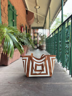 The interior of the Gridlock Tote, showing three compartments with two open sections and a zippered divider.