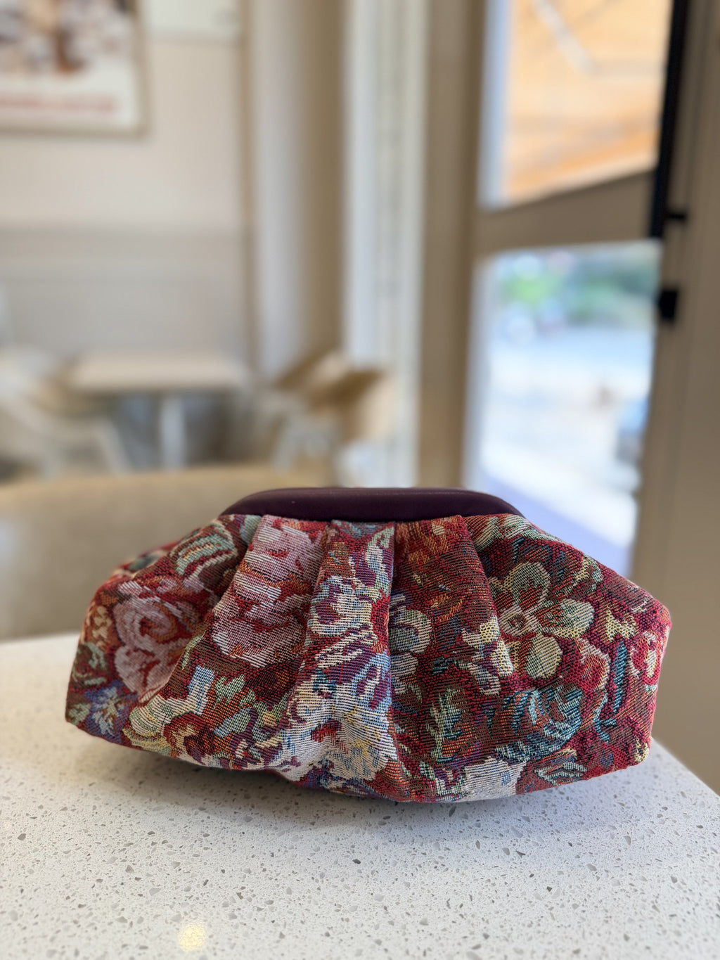Jacquard Cloud bag showing its texturized multicolored weave pattern, soft gathers, and gold sling chain.