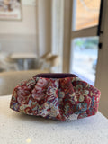 Jacquard Cloud bag showing its texturized multicolored weave pattern, soft gathers, and gold sling chain.