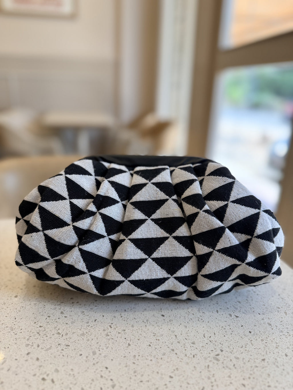 Side view of the bag illustrating its soft, pillowy depth and clean fabric seams.