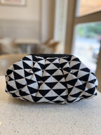 Side view of the bag illustrating its soft, pillowy depth and clean fabric seams.