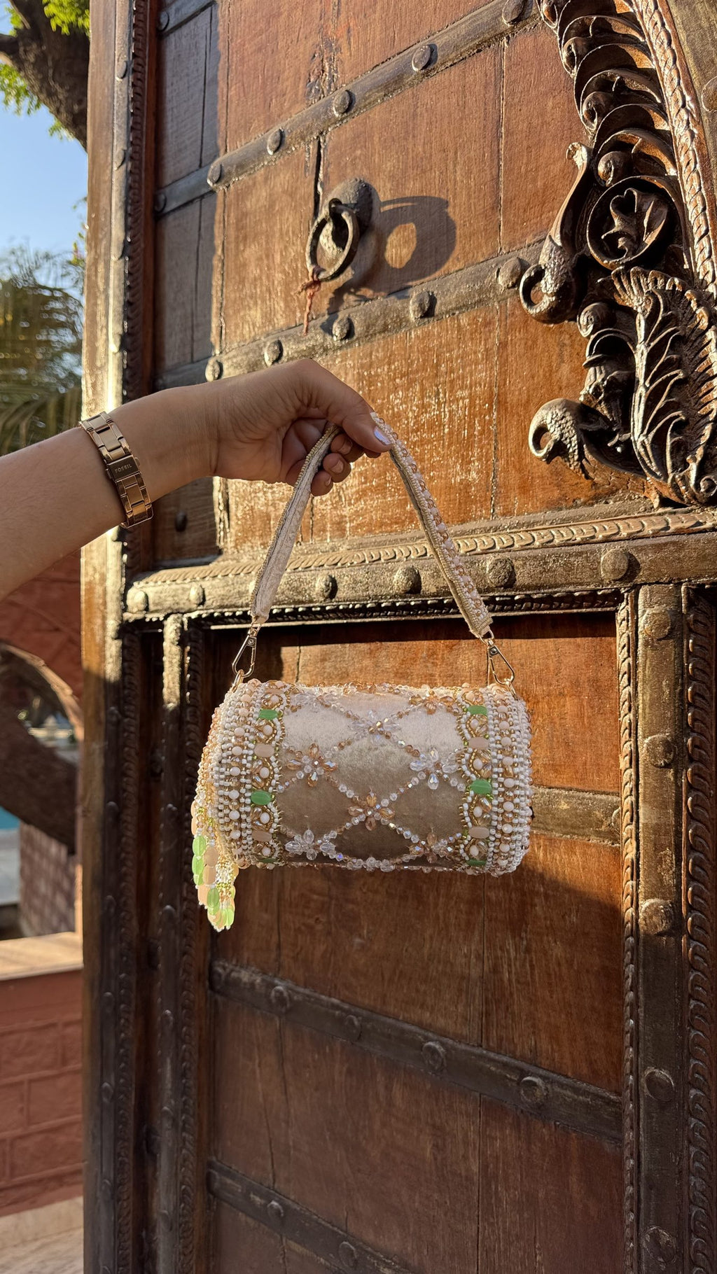 Front view of the Jadau Dreams Potli, displaying its rich velvet fabric and detailed gold beadwork.