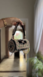 Drawstring detail shot showing the hand-beaded tassels and velvet pull-strings.