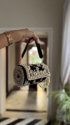 Top view of the Jadau Dreams Potli, displaying its velvet wristlet loop.