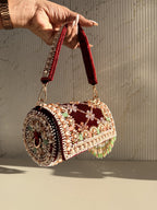 Model carrying the Jadau Dreams Potli by its velvet wristlet loop.