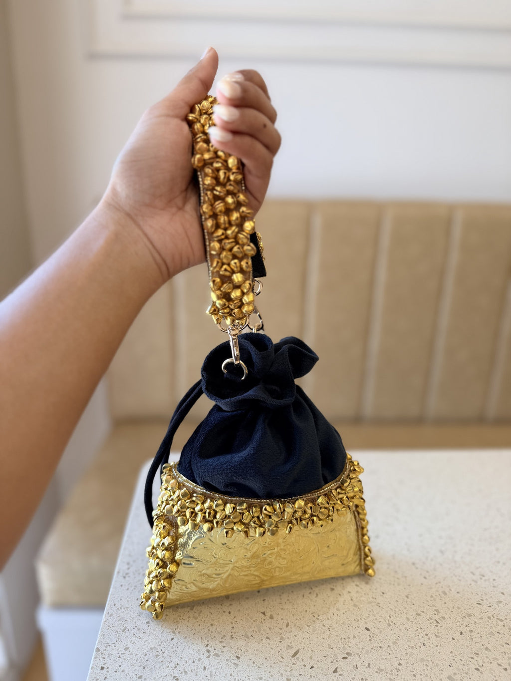 The customizable Jhankar potli displayed alongside festive jewelry and wedding decor.