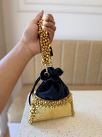 The customizable Jhankar potli displayed alongside festive jewelry and wedding decor.