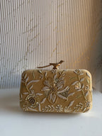 Front view of the Kashi clutch, highlighting the detailed floral gold Zari embroidery.