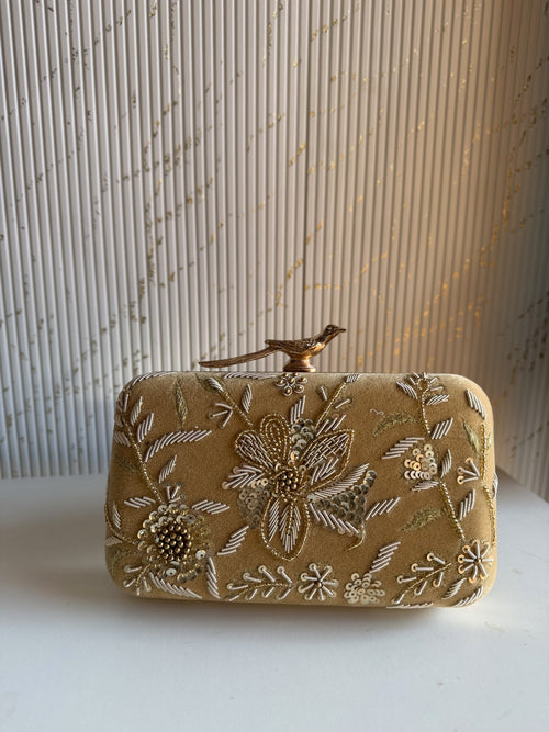 Front view of the Kashi clutch, highlighting the detailed floral gold Zari embroidery.