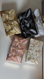 Lifestyle layout of the Kiara clutch next to gold bangles and raw silk coordinates.