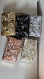 Flat lay of the Kiara clutch showing the gold-tone sling chain attached.