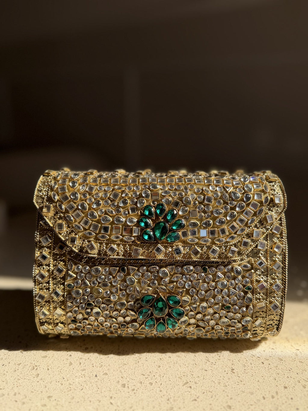 Front profile of the Kundan Peacock clutch, showcasing the symmetry of the handwork.