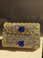 Detailed view of the hand-set Kundan stones arranged in floral patterns on red velvet.