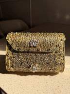 Angled view of the Kundan Peacock bag with its short beaded wrist handle attached.