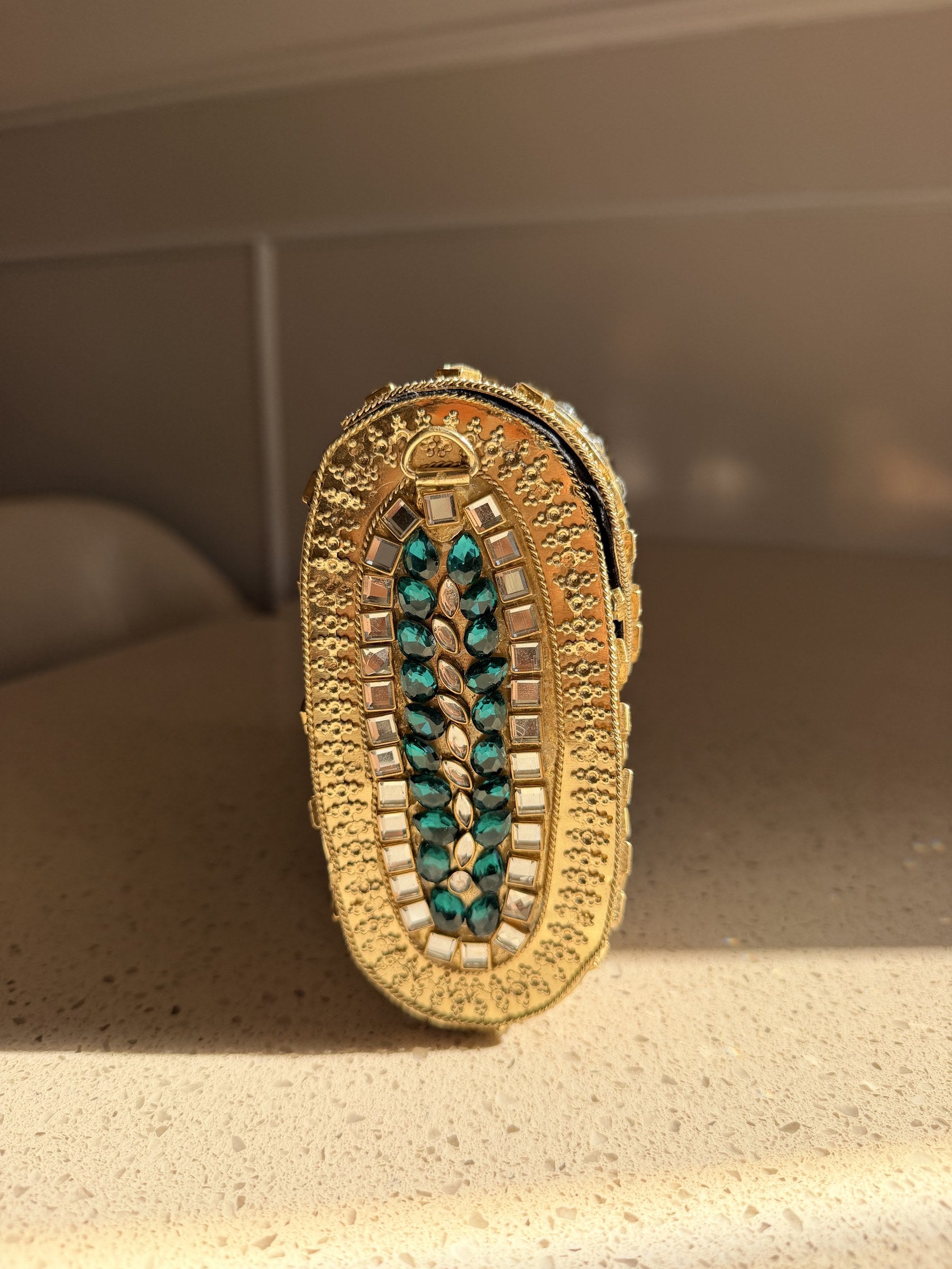 Rear view of the Kundan Peacock clutch showing the green velvet back with neat stitching.