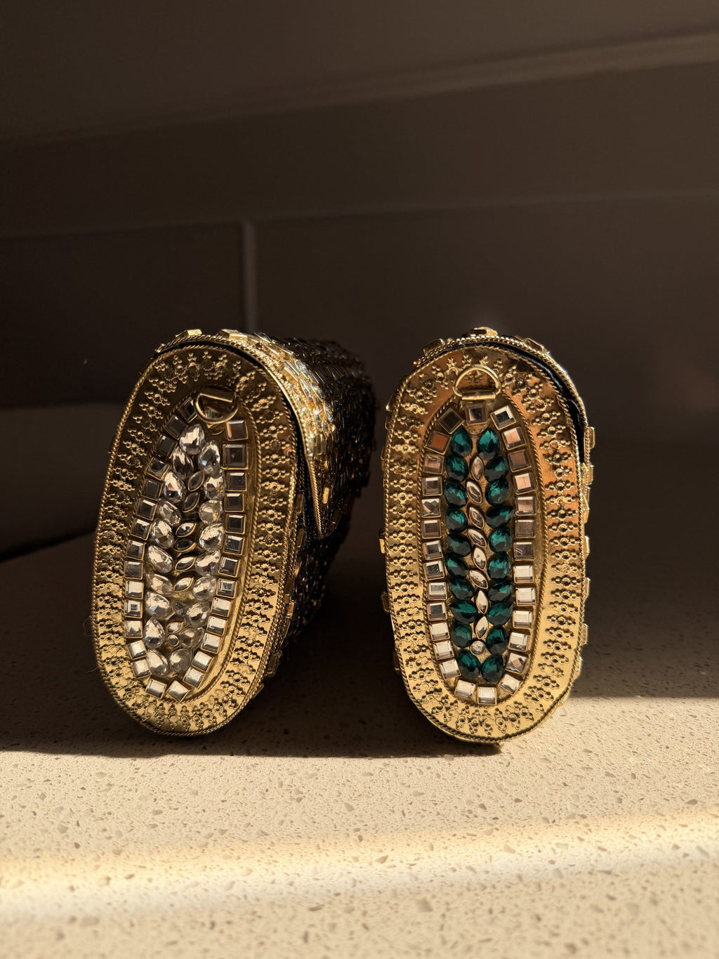 Open view of the Kundan handbag showing the fabric-lined interior and secure push clasp.