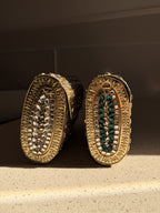 Open view of the Kundan handbag showing the fabric-lined interior and secure push clasp.