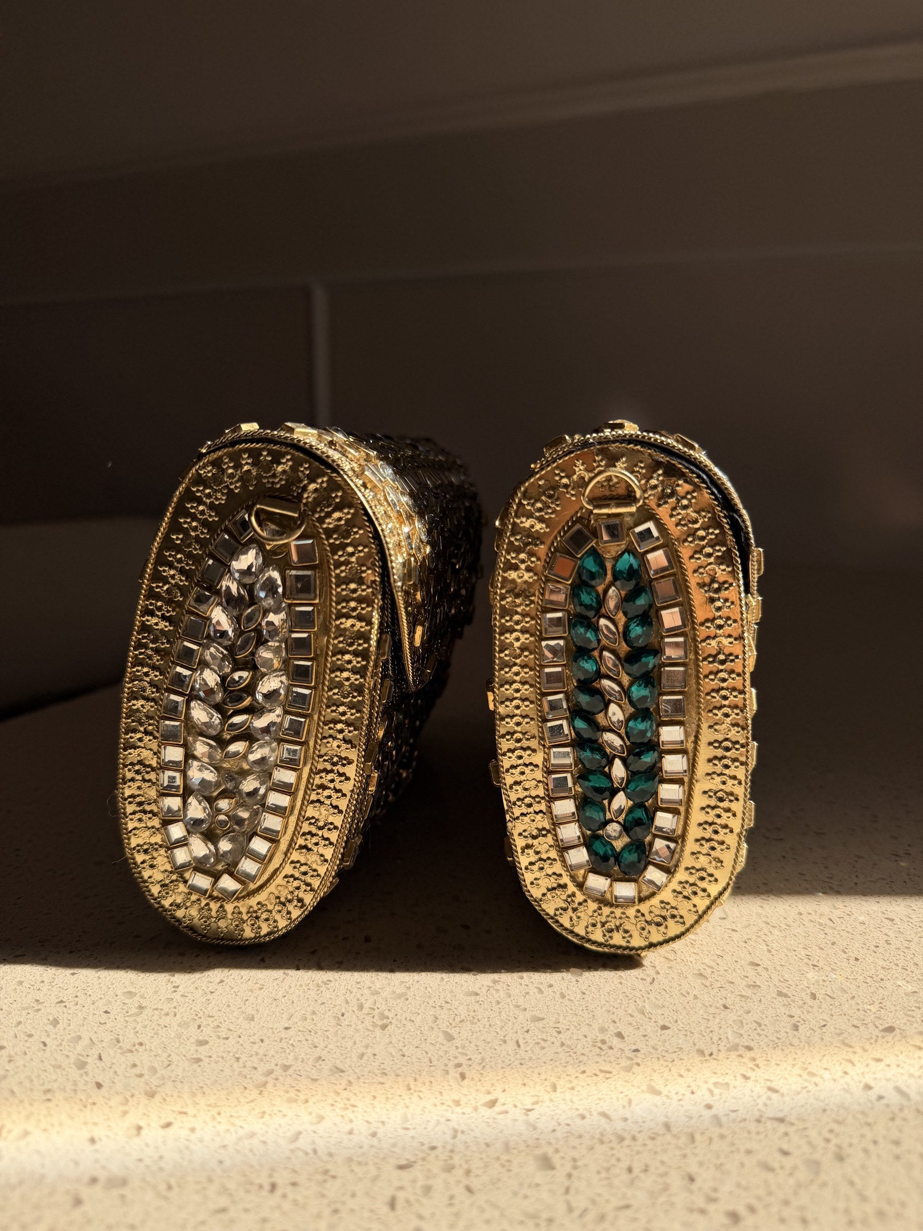 Open view of the Kundan handbag showing the fabric-lined interior and secure push clasp.