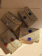 Lifestyle layout of the Kundan Peacock bag next to traditional wedding attire and kundan jewelry.