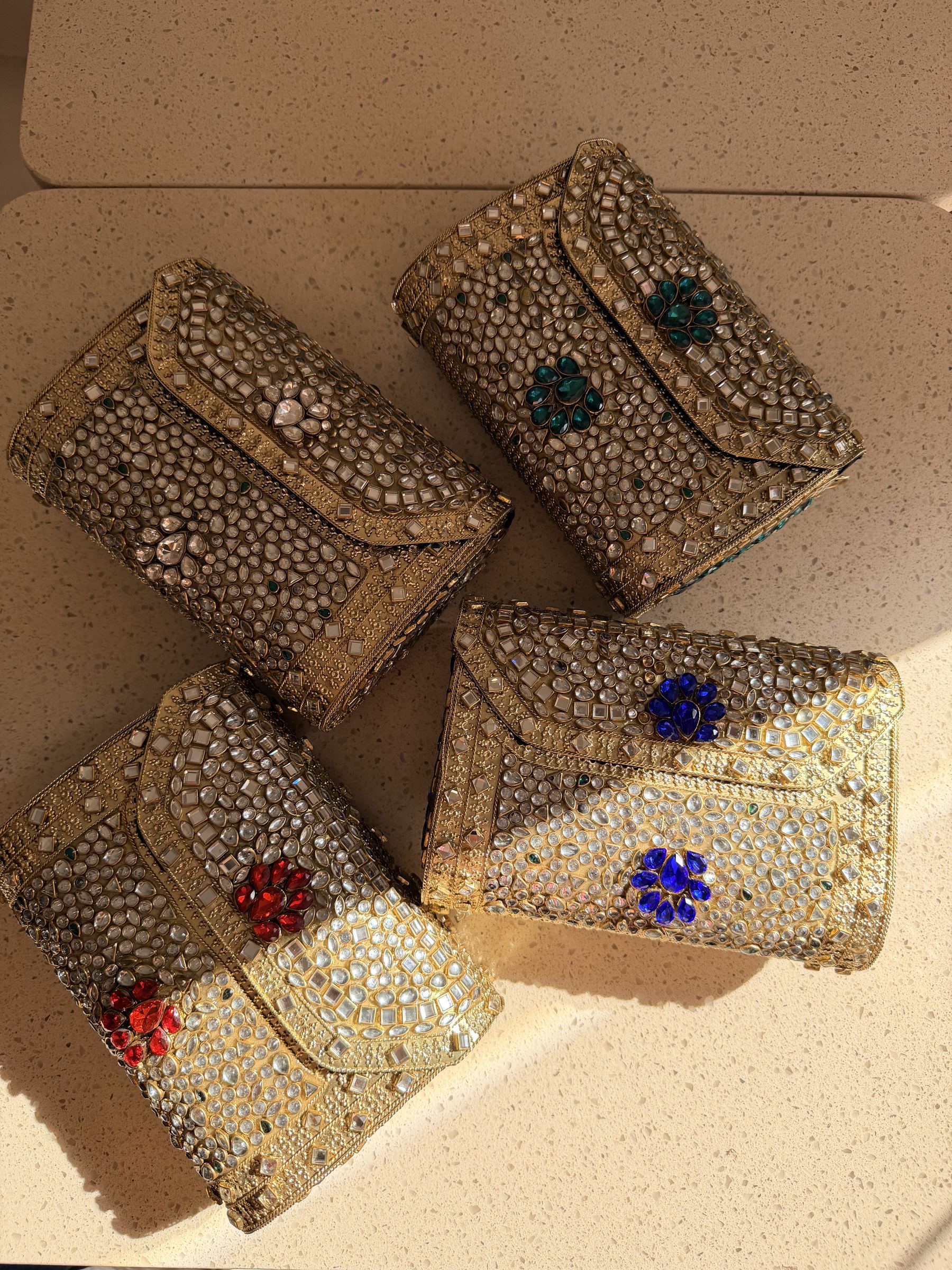 Lifestyle layout of the Kundan Peacock bag next to traditional wedding attire and kundan jewelry.