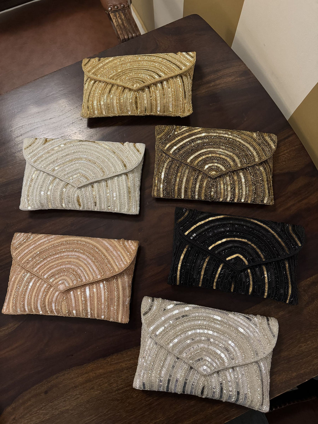 Leher Waves hand-embroidered flap bag showcasing its multicolored wave patterns and short beaded handle.