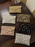 Leher Waves hand-embroidered flap bag showcasing its multicolored wave patterns and short beaded handle.