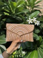 Front view of the Leher Waves flap bag, illustrating the flow of the wave-inspired bead paths.