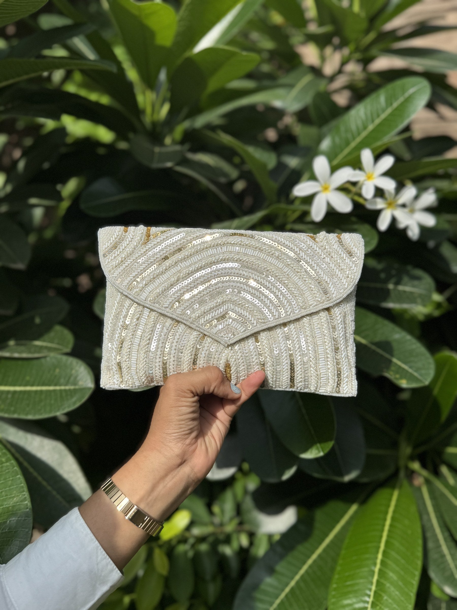 Side profile of the Leher Waves clutch showing its slim, structured rectangular silhouette.