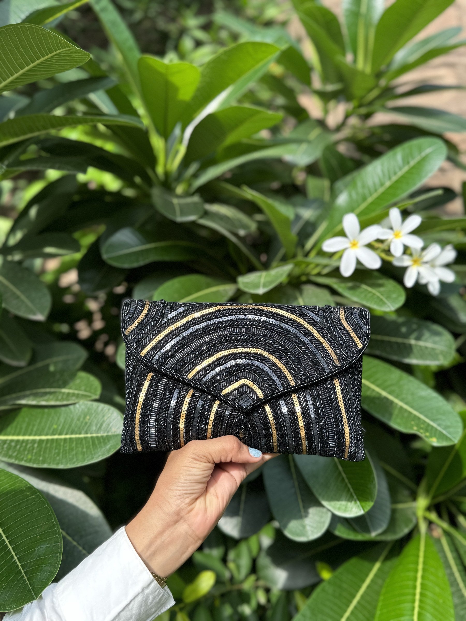 Open view of the Leher Waves handbag displaying its fabric lining, spacious pocket, and snap closure.