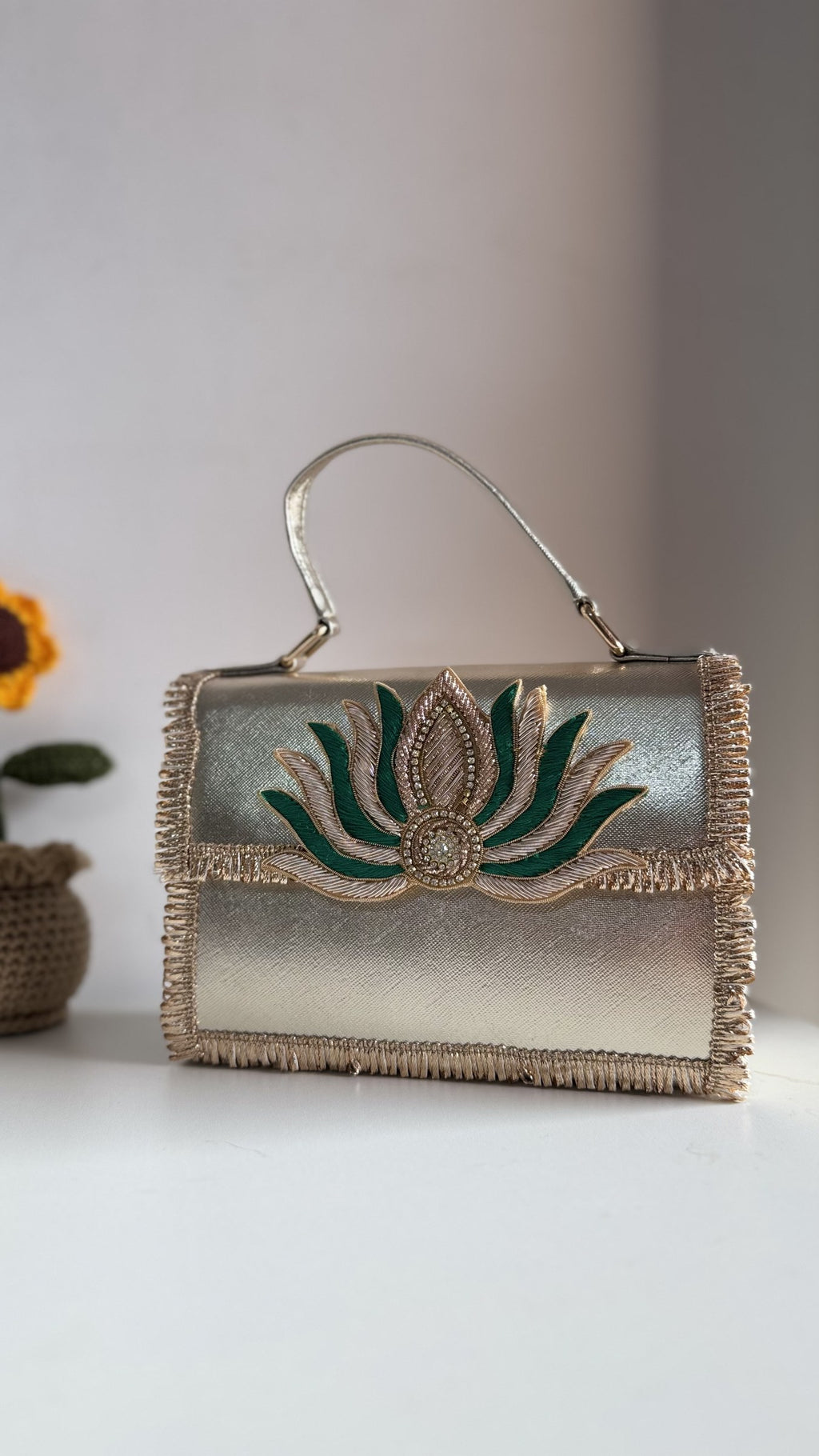 Front view of the Lotus Treasure clutch, showing the details of the gold lotus blossom trim.