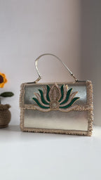 Front view of the Lotus Treasure clutch, showing the details of the gold lotus blossom trim.