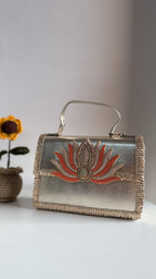 Lotus Treasure clutch in emerald green, showing the deep green panel and gold details.