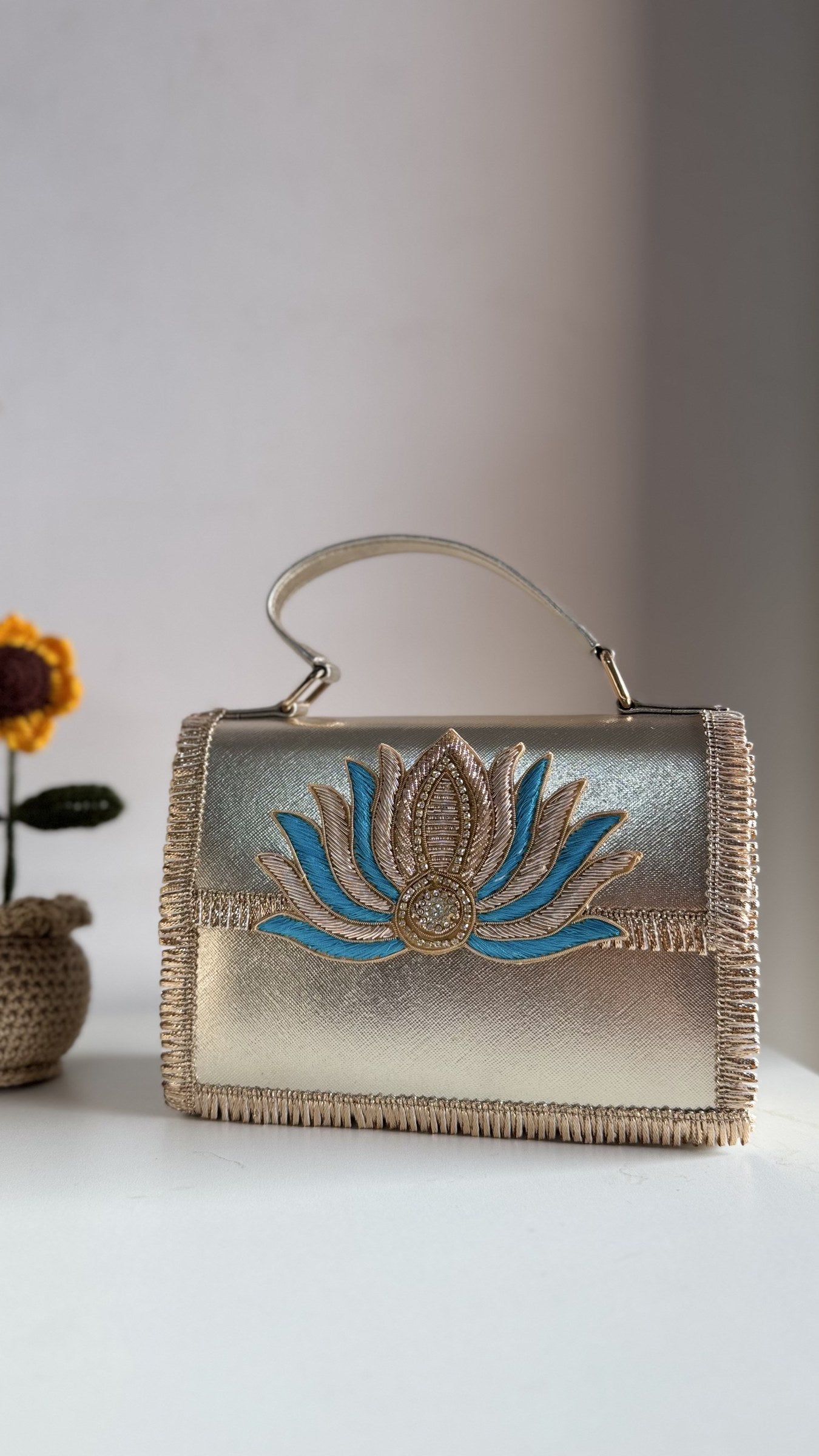 Side profile of the structured Lotus Treasure box clutch, showing its depth.