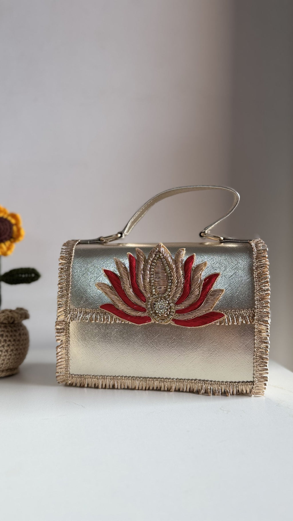 Open view of the Lotus Treasure handbag showing the fabric lining and metal hinge.